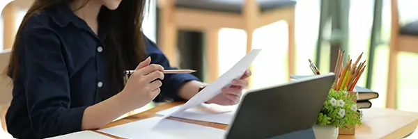 Person sitting at their desk reviewing a dental bill.